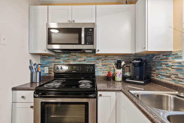 kitchen featuring white cabinets, decorative backsplash, stainless steel appliances, and sink