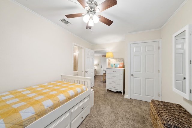 carpeted bedroom with ceiling fan and crown molding