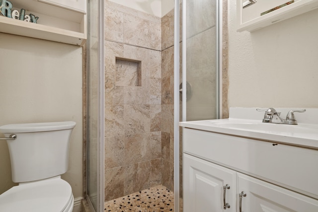 bathroom featuring vanity, toilet, and walk in shower