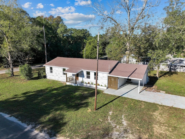274 S 20th St, Defuniak Springs, FL 32435 - view of front of house featuring driveway, a front lawn, and metal roof