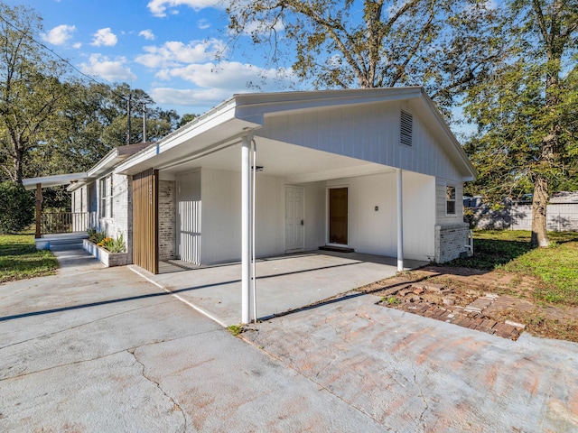 back of house featuring a carport