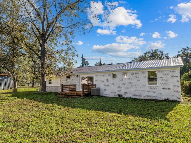 274 S 20th St, Defuniak Springs, FL 32435 - back of house with metal roof, brick siding, central AC, and a wooden deck