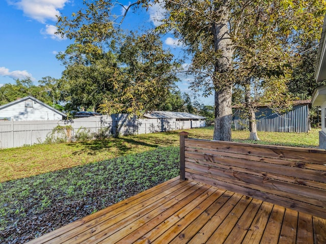 wooden deck featuring a lawn