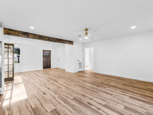 unfurnished living room with ceiling fan, light hardwood / wood-style floors, and beam ceiling