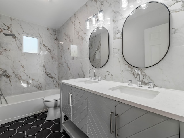 full bathroom featuring toilet, vanity, tile walls, and tub / shower combination