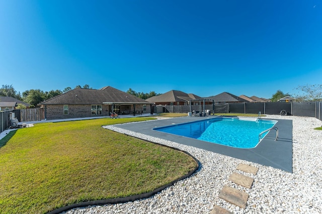 view of pool with a lawn and a patio