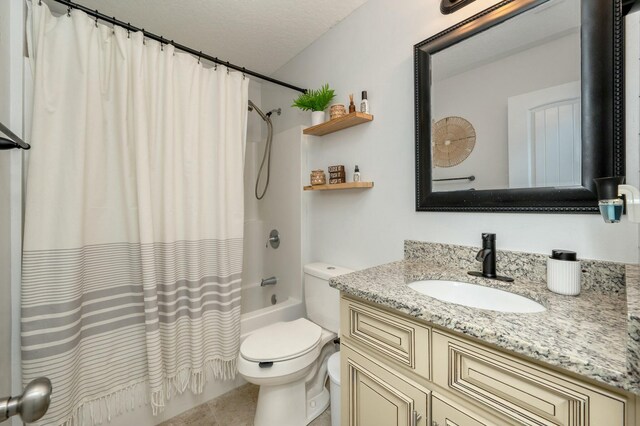 full bathroom featuring vanity, tile patterned flooring, toilet, shower / bathtub combination with curtain, and a textured ceiling