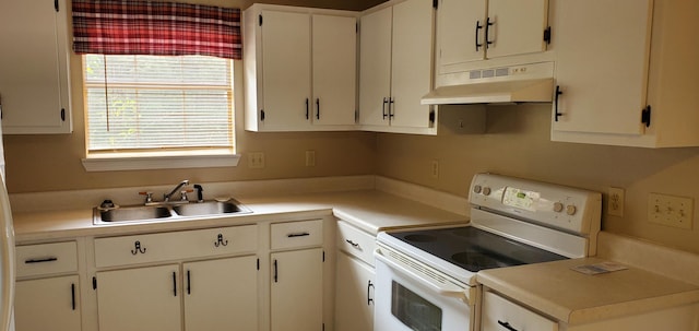 kitchen featuring electric stove, white cabinetry, and sink