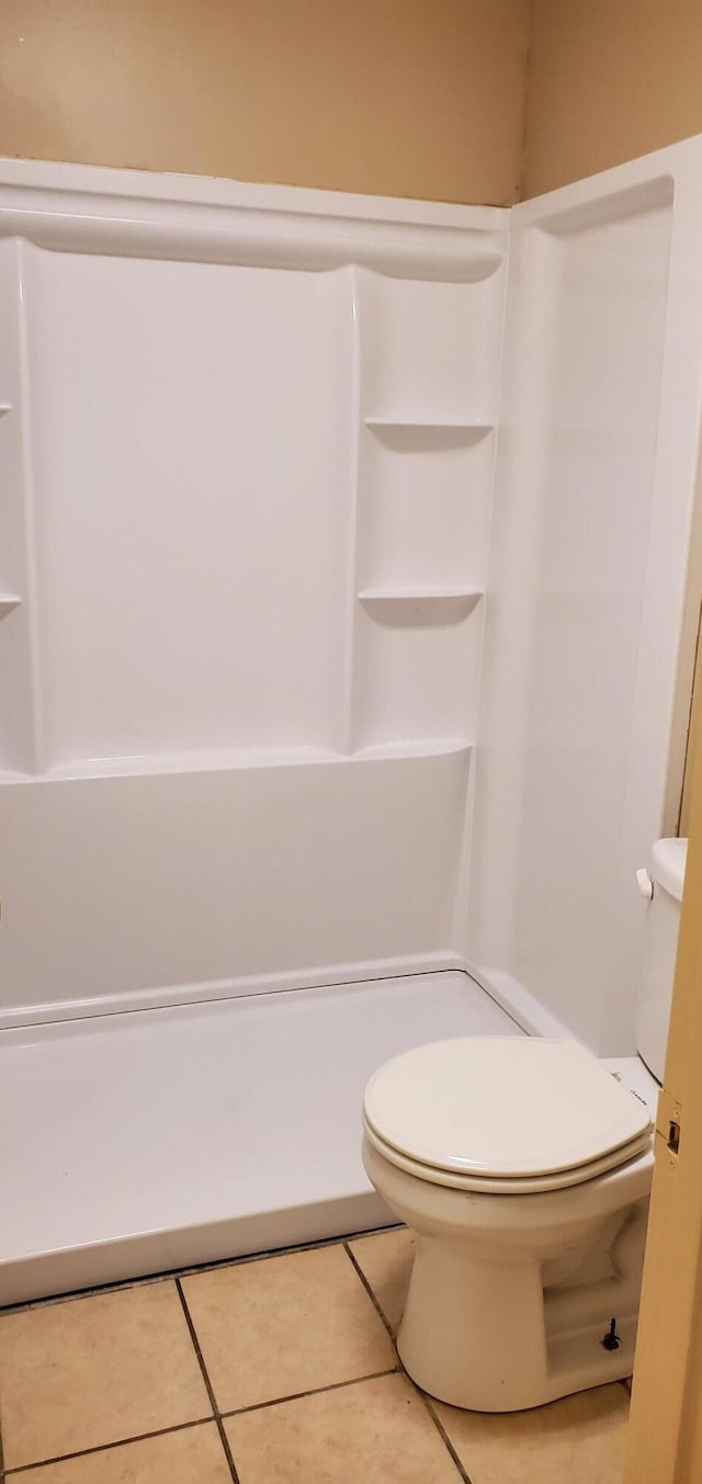 bathroom featuring tile patterned flooring and toilet