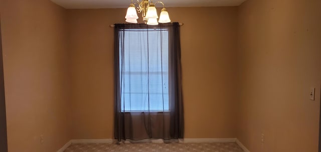 spare room featuring a chandelier