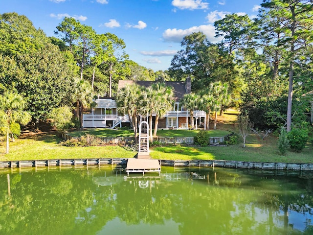 view of dock featuring a yard and a deck with water view