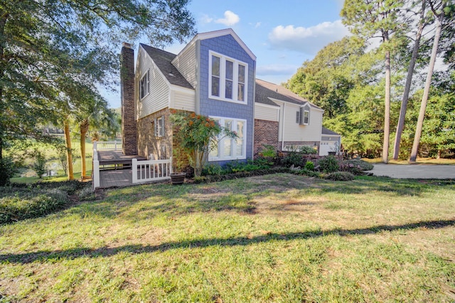 view of property exterior with a wooden deck and a lawn