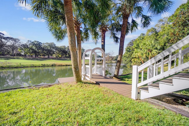 dock area featuring a water view and a lawn