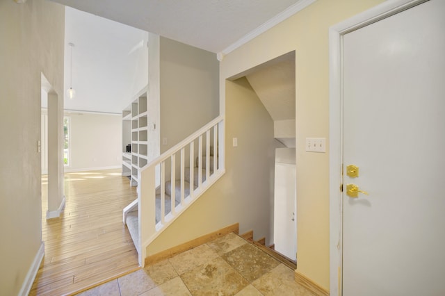 stairs featuring hardwood / wood-style flooring and ornamental molding