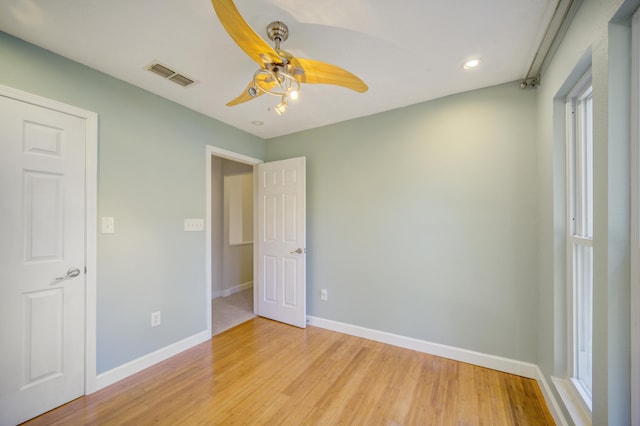 unfurnished bedroom with ceiling fan and light hardwood / wood-style floors