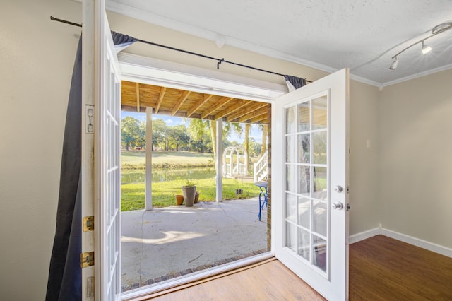 entryway featuring hardwood / wood-style floors, french doors, and crown molding