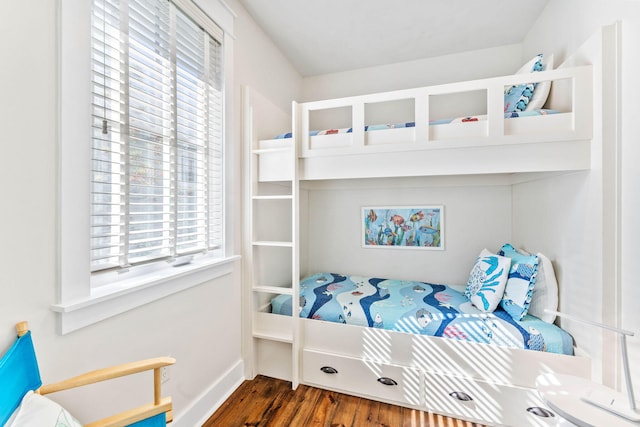 bedroom featuring dark hardwood / wood-style floors and multiple windows