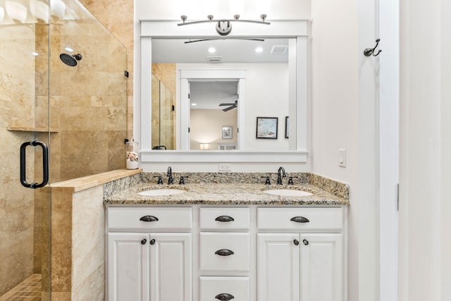 bathroom with ceiling fan, walk in shower, and vanity