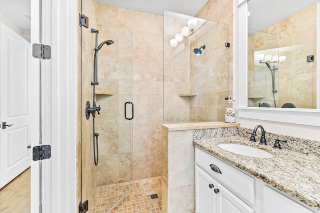 bathroom featuring vanity, hardwood / wood-style flooring, and walk in shower