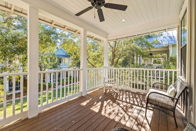 sunroom / solarium featuring ceiling fan