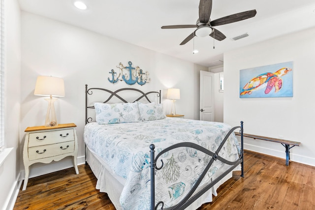 bedroom with dark hardwood / wood-style floors and ceiling fan