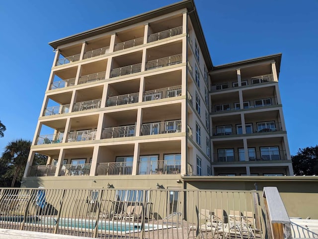 view of building exterior with a community pool