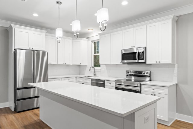 kitchen featuring white cabinetry, a center island, and stainless steel appliances