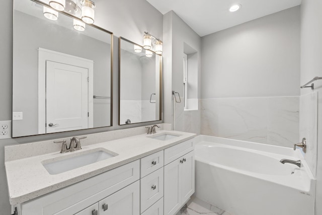 bathroom featuring vanity and a tub