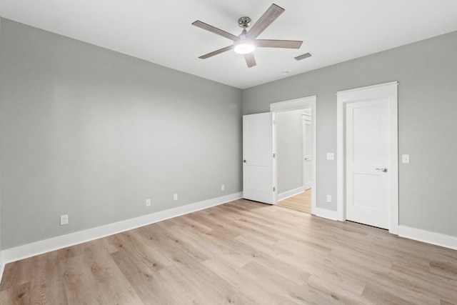 unfurnished bedroom with ceiling fan and light wood-type flooring