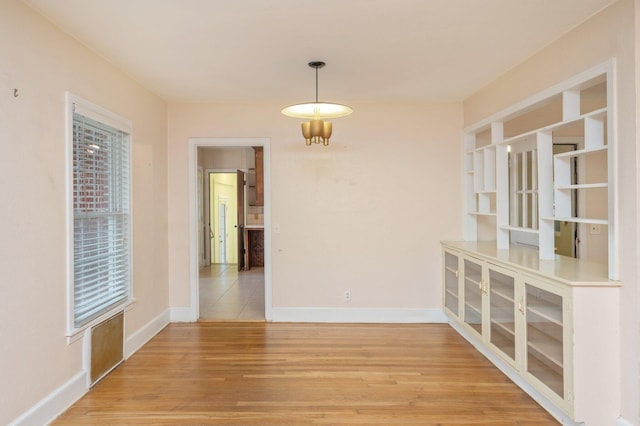 unfurnished dining area with wood-type flooring