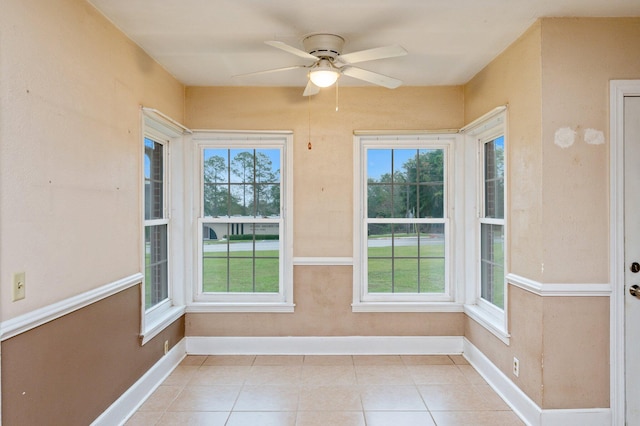 unfurnished sunroom with ceiling fan and a wealth of natural light