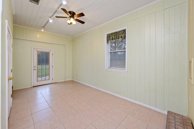 tiled empty room featuring ornamental molding, rail lighting, and ceiling fan