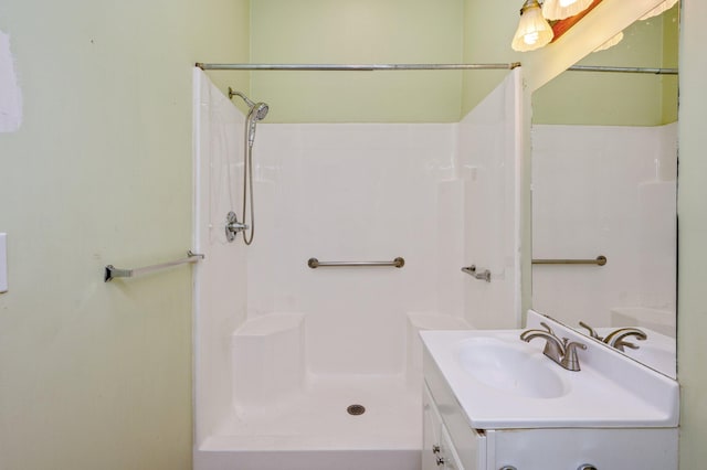 bathroom featuring a shower and vanity