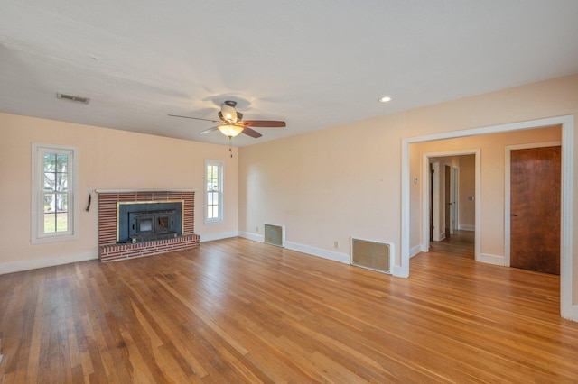 unfurnished living room featuring ceiling fan and light wood-type flooring