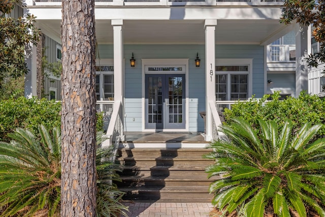 doorway to property featuring covered porch and french doors