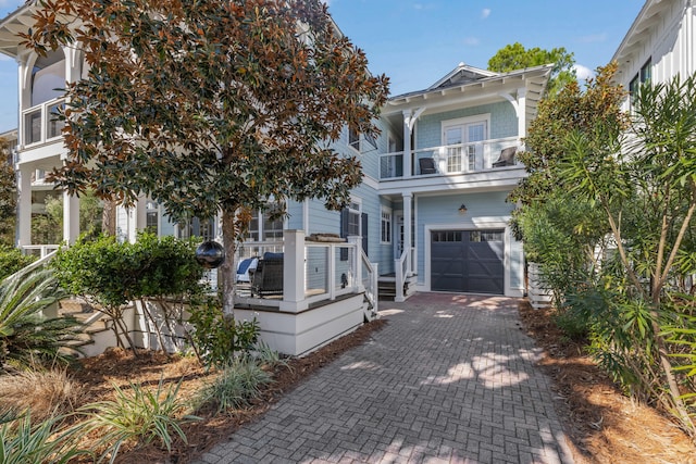 view of front of home with a balcony and a garage