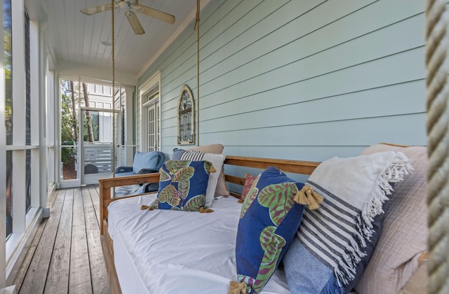 sunroom / solarium featuring ceiling fan and wood ceiling