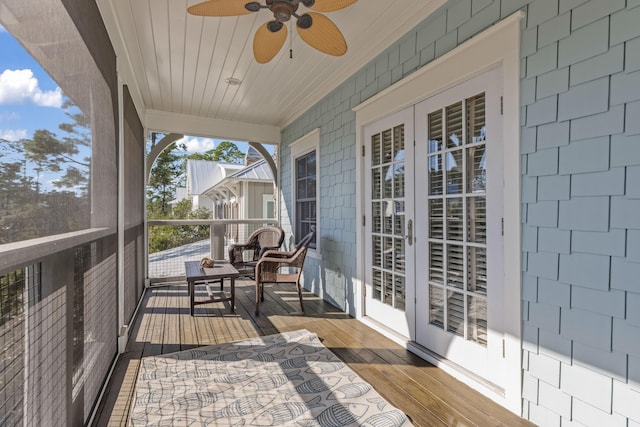 unfurnished sunroom with french doors and ceiling fan