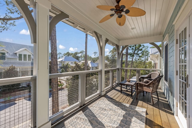 sunroom with ceiling fan and wood ceiling