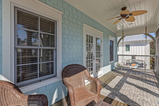 wooden terrace featuring a porch and ceiling fan