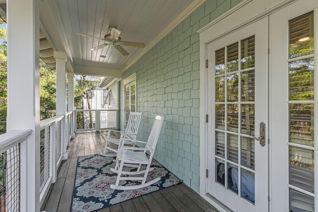 wooden terrace with ceiling fan and a porch