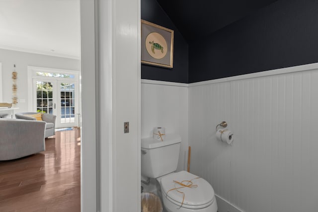 bathroom featuring lofted ceiling, french doors, crown molding, hardwood / wood-style flooring, and toilet