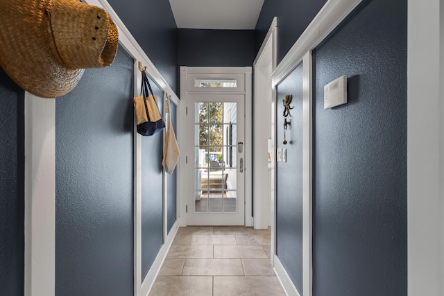 doorway to outside featuring light tile patterned floors