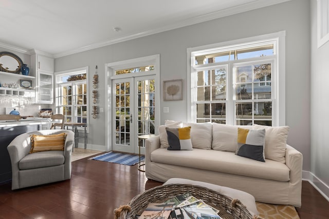 living room with plenty of natural light, dark hardwood / wood-style floors, and ornamental molding