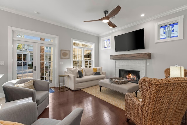 living room featuring dark hardwood / wood-style flooring, ornamental molding, a fireplace, and french doors