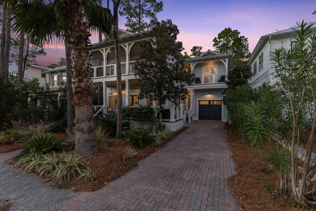 view of front of home featuring a balcony and a garage