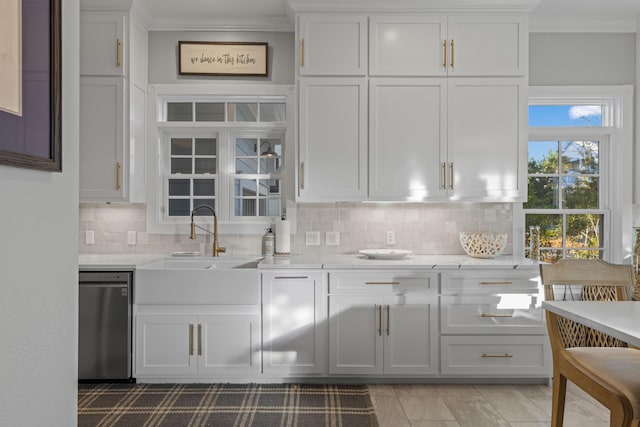 kitchen featuring dishwasher, white cabinetry, and light stone countertops