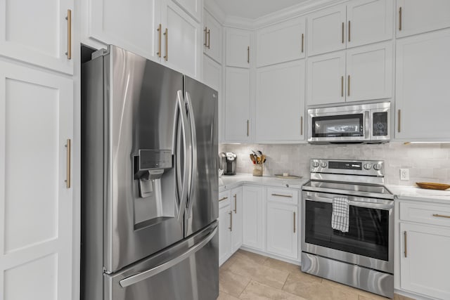 kitchen with white cabinets, light stone countertops, appliances with stainless steel finishes, and tasteful backsplash