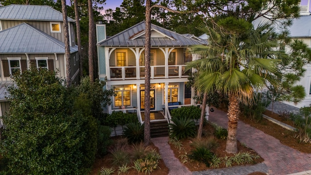 view of front of property with covered porch and a balcony