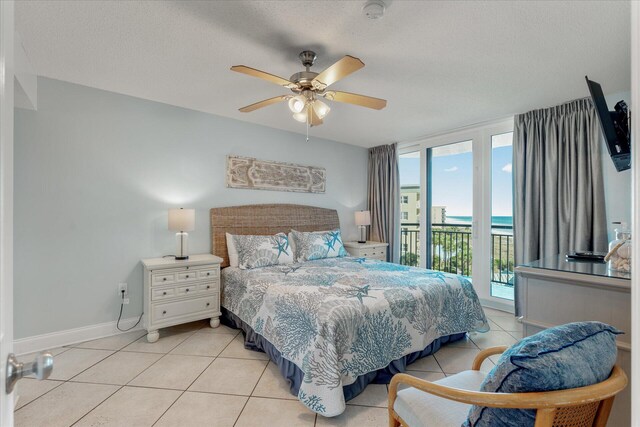 tiled bedroom featuring ceiling fan, a textured ceiling, and access to outside